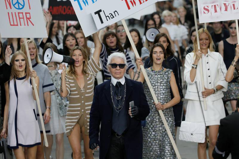 Lagerfeld leads his placard-wielding models down the runway for spring / summer 2015 ready-to-wear. The whole stage was about protesting. Reuters