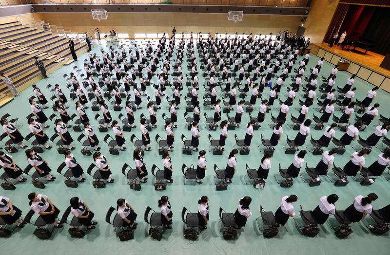 Pupils attend a ceremony for the reopening of the school in Higashiosaka, Osaka prefecture, Japan. AFP