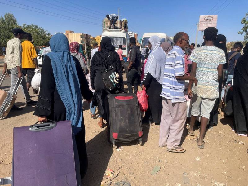 People gather at a bus station to escape Khartoum. Reuters