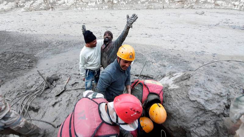 A man reacts after being pulled to safety by Indo-Tibetan Border Police personnel during rescue operations following flash flooding in the Tapovan area of India's northern state of Uttarakhand. AP