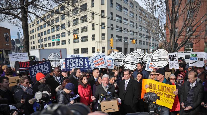 New York City Councillor Jimmy Van Bramer, center, speaks during a coalition rally and press conference of elected officials, community organizations and unions opposing Amazon headquarters getting subsidies to locate in the New York neighborhood of Long Island City, Queens, Wednesday Nov. 14, 2018, in New York. (AP Photo/Bebeto Matthews)