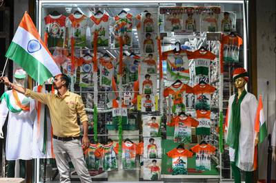 A shopkeeper arranges an Indian flag at his store in Mumbai. AFP
