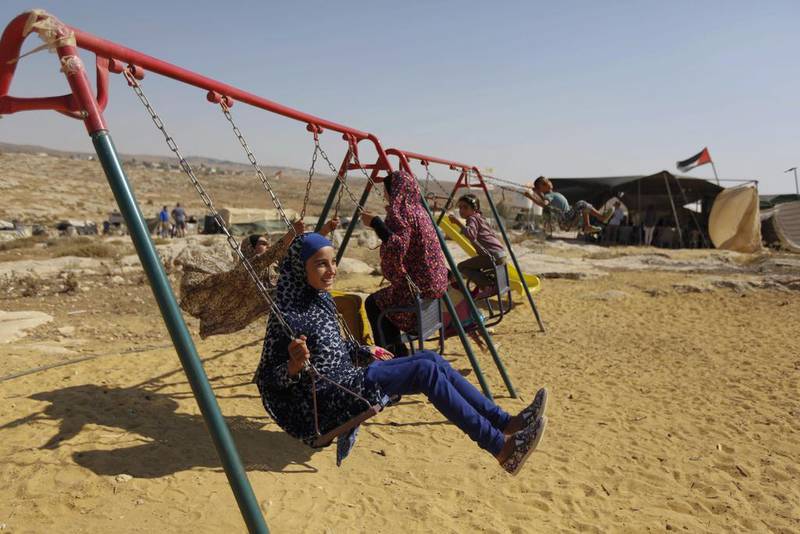 Palestinian children play in the village of Susiya, south of the West Bank city of Hebron. Majdi Mohammed / AP Photo
