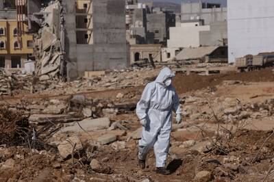 A rescuer walks amid the rubble of destroyed buildings in the Libyan city of Derna on Sunday. Reuters