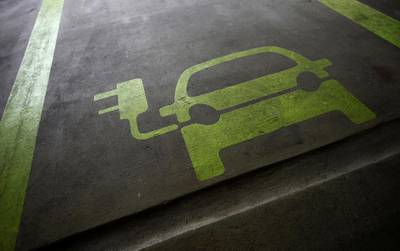 FILE PHOTO: A sign is painted on a parking space for electric cars inside a car park in Hong Kong January 29, 2012. REUTERS/Tyrone Siu/File Photo