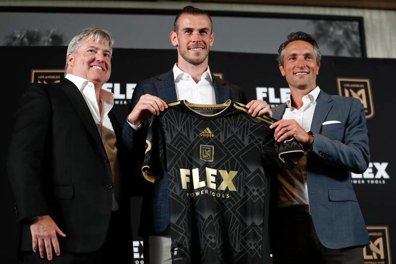 Bew Los Angeles FC signing Gareth Bale holds up a jersey as he poses with lead managing owner of LAFC, Larry Berg, left, and LAFC general manager John Thorrington during a news conference at Banc of California Stadium in Los Angeles, California, USA, 11 July 2022. EPA 