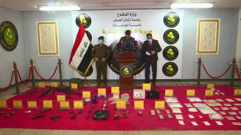 Authorities display the drugs and weapons seized. AP