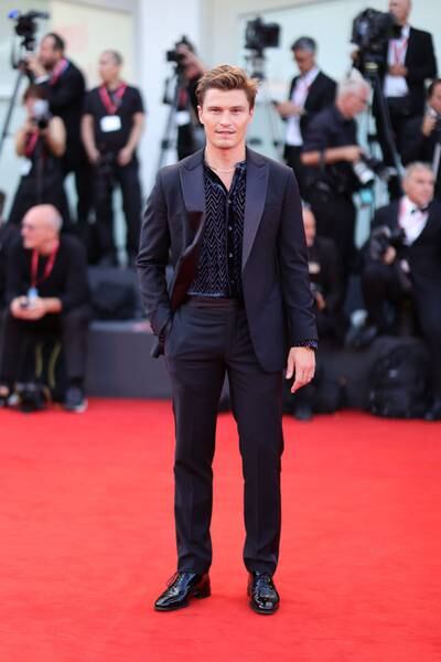 Oliver Cheshire wears an open-collar black Armani tuxedo. Getty Images 