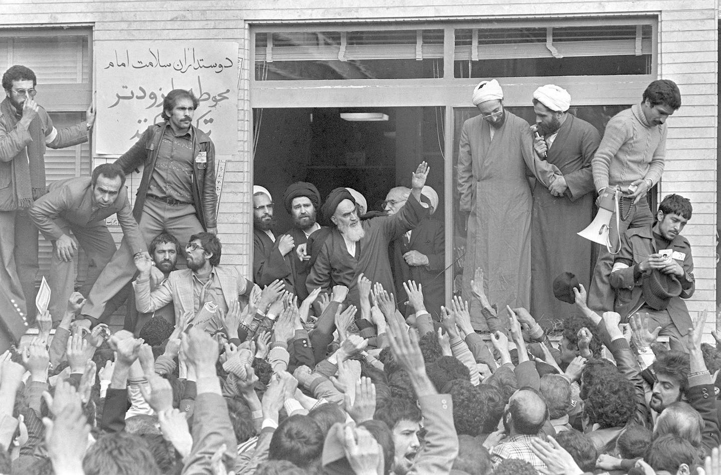 FILE - In this Feb. 1, 1979 file photo, Ayatollah Ruhollah Khomeini, center, waves to followers as he appears on the balcony of his headquarters in Tehran, Iran. Friday, Feb. 1, 2019 marks the 40th anniversary of Khomeini's arrival in Iran, setting the stage for the country's 1979 Islamic Revolution that changed the country‚Äôs history for decades to come. (AP Photo/Campion, File)