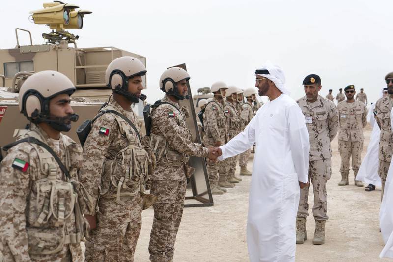 AL DHAFRA REGION, ABU DHABI, UNITED ARAB EMIRATES - April 08, 2018: HH Sheikh Mohamed bin Zayed Al Nahyan Crown Prince of Abu Dhabi Deputy Supreme Commander of the UAE Armed Forces (4th R),  greets a member of the UAE Armed Forces, during a military exercise titled ‘Homat Al Watan 2 (Protectors of the Nation)’, at Al Hamra Camp. Seen with HH Major General Pilot Sheikh Ahmed bin Tahnoon bin Mohamed Al Nahyan, Chairman of the National and Reserve Service Authority (3rd R).
( Rashed Al Mansoori / Crown Prince Court - Abu Dhabi )
---