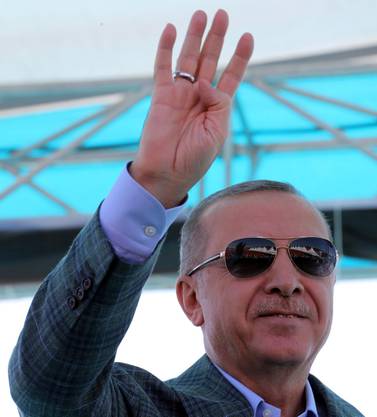 Turkey's President Recep Tayyip Erdogan gestures as he addresses his supporters in Bursa, Turkey, Sunday, Aug. 4, 2019. Erdogan has renewed a pledge for a cross-border military operation into northeastern Syria and said: "We've entered Afrin, Jarablus, al-Bab. Now we will enter the east of the Euphrates." (Presidential Press Service via AP, Pool)