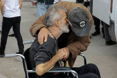 An ethnic Armenian embraces a man upon arrival in Armenia's Goris. AP