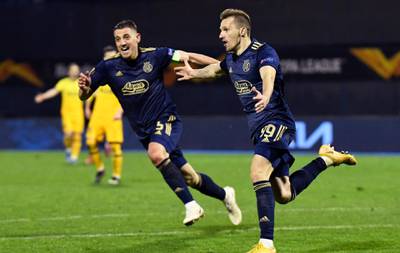ZAGREB, CROATIA - MARCH 18: Mislav Orsic of GNK Dinamo Zagreb celebrates with Arijan Ademi after scoring their side's third goal and his hat-trick during the UEFA Europa League Round of 16 Second Leg match between Dinamo Zagreb and Tottenham Hotspur at Stadion Maksimir on March 18, 2021 in Zagreb, Croatia. Sporting stadiums around Europe remain under strict restrictions due to the Coronavirus Pandemic as Government social distancing laws prohibit fans inside venues resulting in games being played behind closed doors. (Photo by Jurij Kodrun/Getty Images)