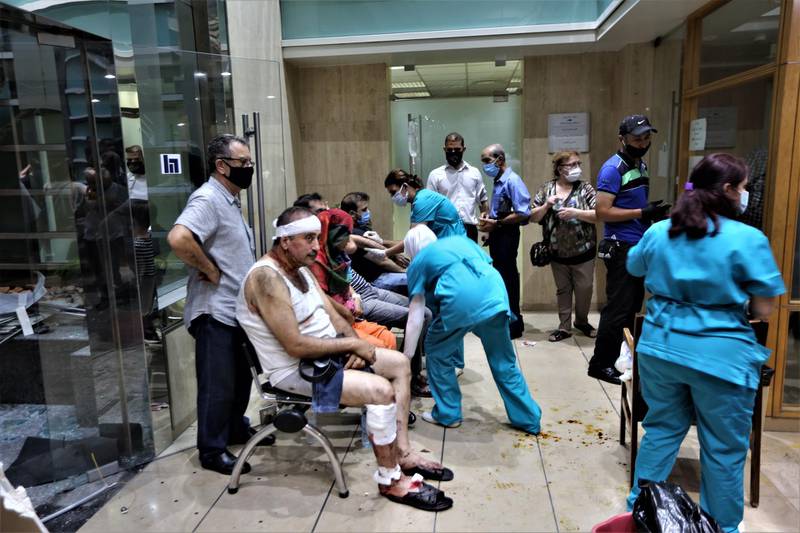 People injured in the Beirut Port explosion receive first aid at Najjar Hospital in Al Hamra area in Beirut.  EPA