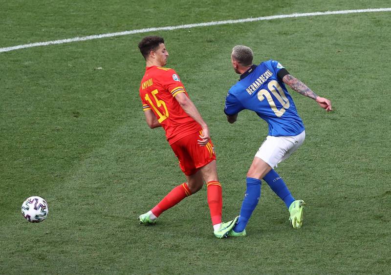 Wales defender Ethan Ampadu was sent off for this challenge on Italy's Federico Bernardeschi. Reuters