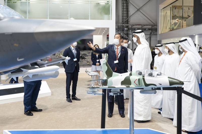 Sheikh Mohamed tours the Dubai Airshow with Sheikh Mohamed bin Hamad, second right, and Faisal Al Bannai, right.