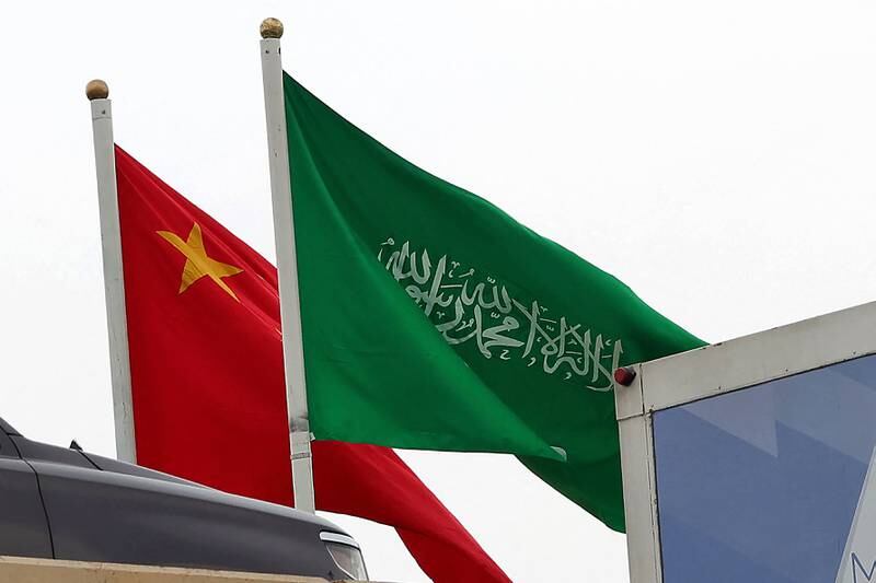 Chinese and Saudi Arabia's flags fly side by side ahead of Xi Jinping's visit to Riyadh. AFP