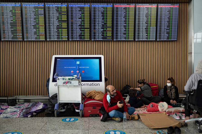Passengers wait in Istanbul Airport on January 25, 2022, after flights were cancelled due to a blizzard. AFP