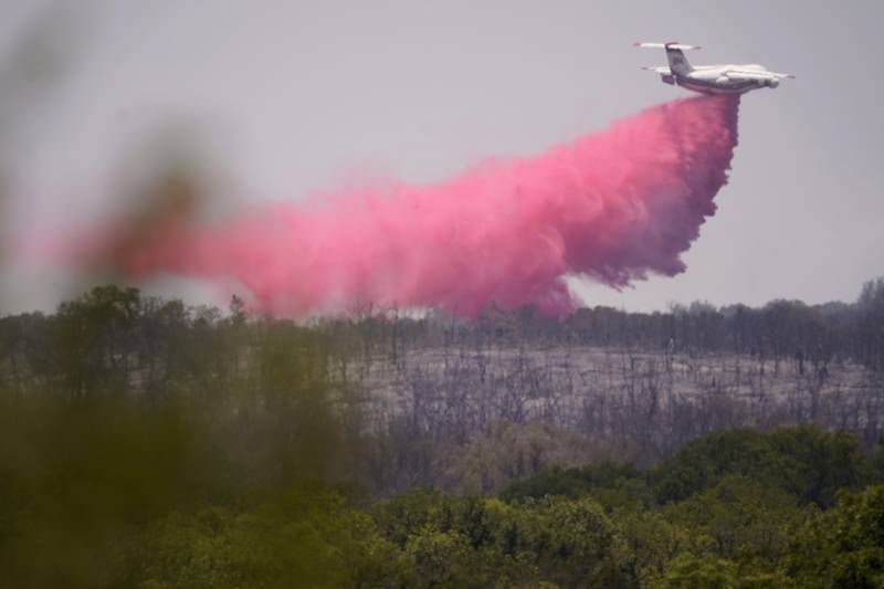 An aircraft drops retardant on a fire near Glen Rose, Texas.  Officials say a mandatory evacuation order issued because of a wildfire in North Texas has been lifted although the threat of fires remains high.  AP Photo 
