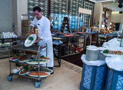 Abu Dhabi, U.A.E., May 21, 2018. InterContinental Abu Dhabi.  BYBLOS Arabic Restaurant meal preparations by chef and staff for Iftar.  A chefs assistant prepares the food display. Victor Besa / The NationalSection:  WeekendReporter:  Saeed Saeed