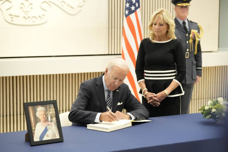 US President Joe Biden signs a condolence book with first lady Jill Biden while paying respects following the passing of Queen Elizabeth at the British embassy in Washington. Bloomberg