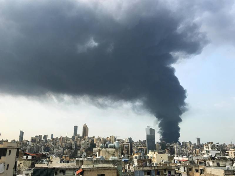 Smoke rises over Beirut's port area as seen from Sin-el-fil. Reuters
