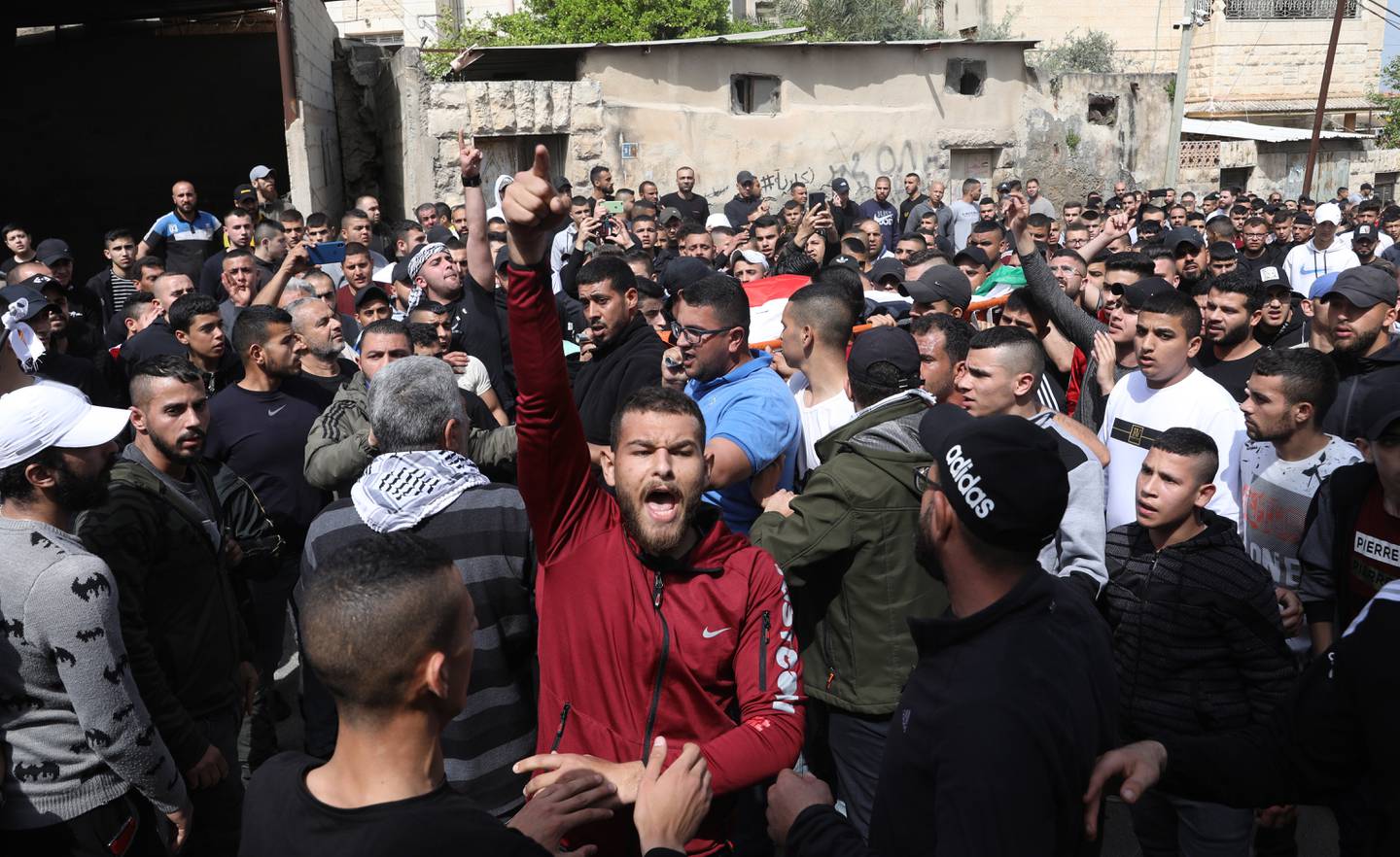 Palestinians carry the body of Mohamed Zakarneh, 17, during his funeral in the West Bank city of Jenin on April 11. EPA