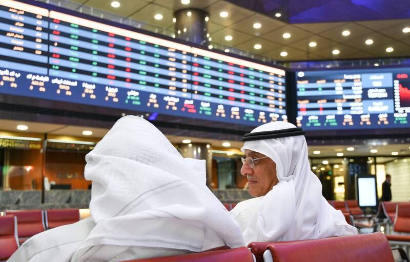 Traders follow stock prices at the Kuwait Stock Exchange in Kuwait City. EPA