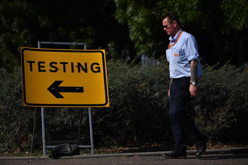 Pedestrians walk past a sign for a Covid-19 test centre in Southend-on-Sea, east of London. AFP