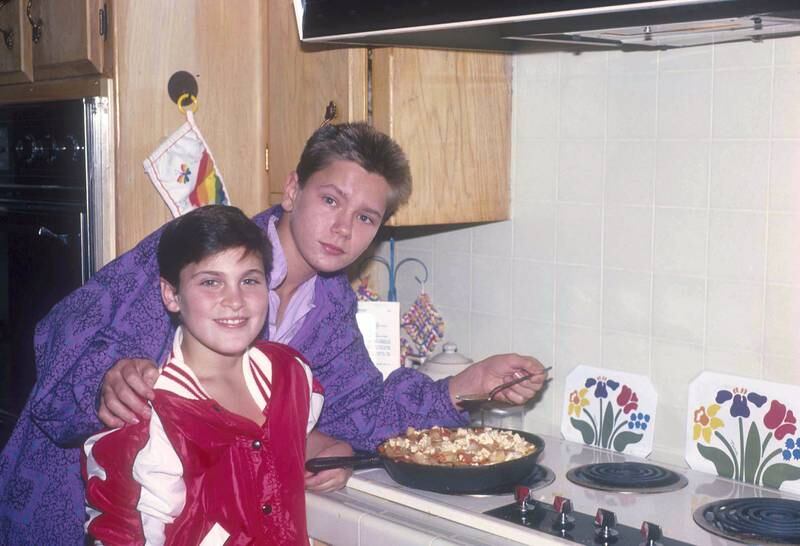 American actors Joaquin and River Phoenix cooking at their home in Los Angeles, California, US, circa 1985.  (Photo by Dianna Whitley/Getty Images)