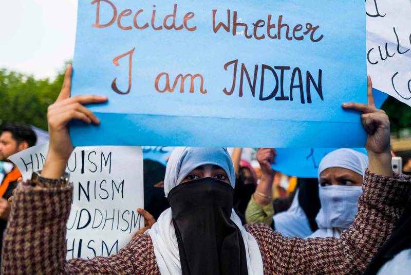 Protesters display placards during a demonstration against the Indian government's Citizenship Amendment Bill in New Delhi. AFP