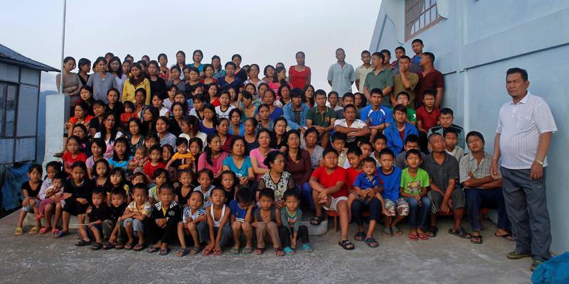 FILE PHOTO: ATTN EDITORS: IMAGE 17 OF 51 OF PICTURE PACKAGE '7 BILLION, 7 STORIES - THE WORLD'S LARGEST FAMILY'. SEARCH 'BAKTAWNG' TO SEE ALL IMAGES  Family members of Ziona (R) poses for group photograph outside their residence in Baktawng village in the northeastern Indian state of Mizoram, October 7, 2011. Ziona is the head of a religious sect called "Chana," which allows polygamy and was founded by his father Chana in 1942. Ziona has 39 wives, 94 children and 33 grandchildren. He lives in his 4 storey 100-room house with 181 members of his family. The world's population will reach seven billion on 31 October 2011, according to projections by the United Nations.   Picture taken October 7, 2011.  REUTERS/Adnan Abidi (INDIA  - Tags: SOCIETY)   FOR BEST QUALITY IMAGE: ALSO SEE  GF2E7BI0OV501/File Photo