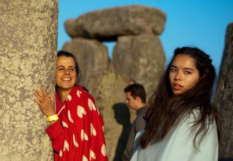 A reveller hugs a stone of the Stonehenge ancient monument in Wiltshire, Britain, 21 June 2014, after witnessing the sunrise in celebration of the Summer Solstice. Tens of thousands of summer solstice revellers celebrated the beginning of the longest day of the year at Stonehenge. Will Oliver / EPA