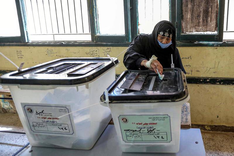A woman casts her ballot at a polling station in El Ayyat, south of the Egyptian capital, during the first stage of the lower house elections. AFP