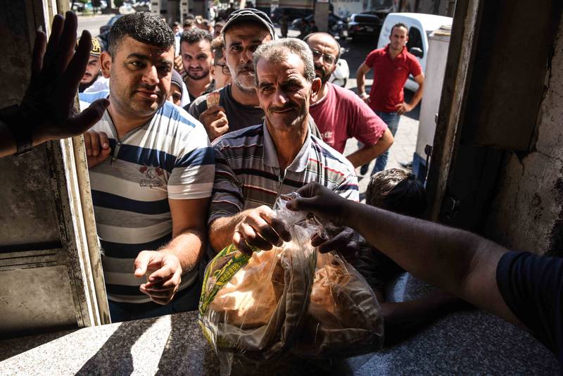 People queue for bread as shortages continue. Elizabeth Fitt for The National