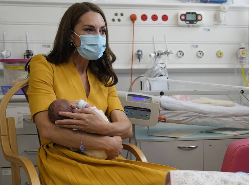 Kate, Princess of Wales, cradles baby Bianca during a visit to the Royal Surrey County Hospital's maternity unit in Guilford, England. AP