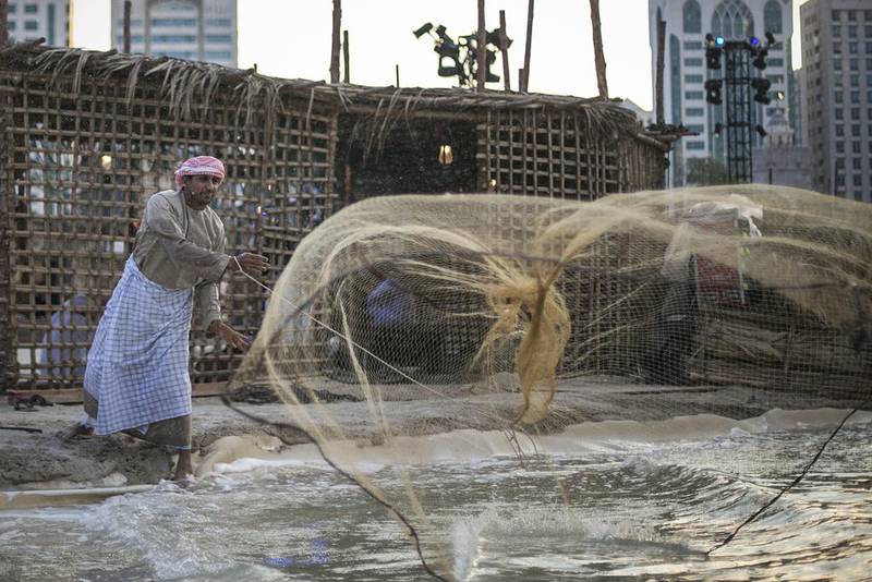 A fisherman casts his net in the Ocean Zone at this year’s Qasr Al Hosn Festival. Mona Al Marzooqi for The National