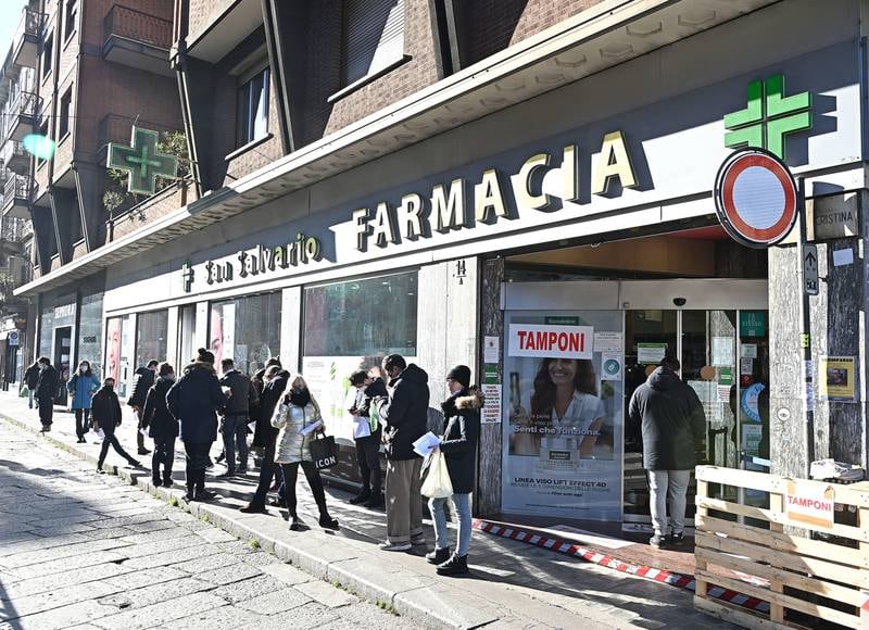 People queue up outside a pharmacy to have swab tests in Turin, Italy. EPA