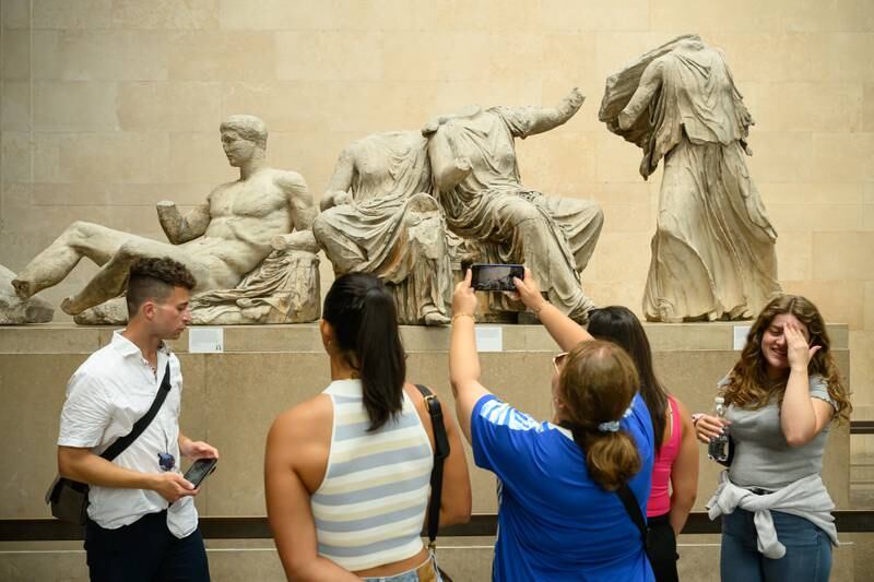 Visitors to the British Museum this week admire a selection of items from the collection of ancient Greek sculptures known as The Elgin Marbles. Getty Images