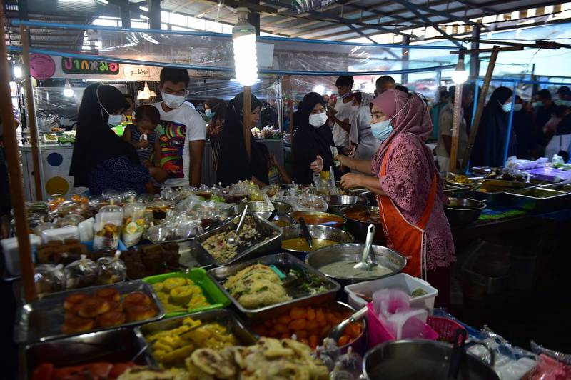 People shop at a market during Ramadan in Thailand's southern province of Narathiwat. AFP