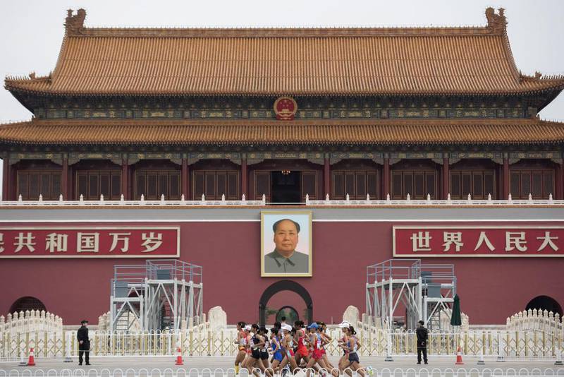 Athletes run past a portrait of Mao Zedong in Tiananmen Square as they compete in the final of the women’s marathon athletics event at the 2015 IAAF World Championships at the “Bird’s Nest” National Stadium in Beijing.  Fred Dufour / AFP
