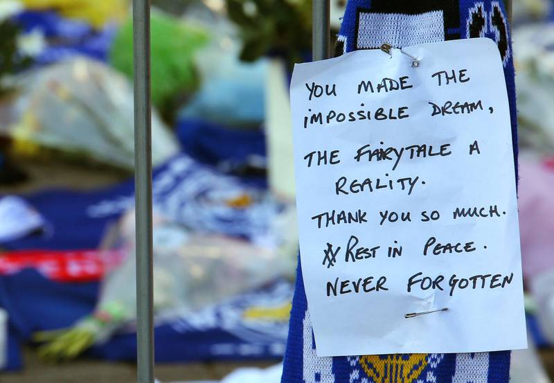 Flowers and messages of condolence are seen outside the stadium. EPA