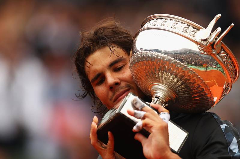 PARIS, FRANCE - JUNE 11:  Rafael Nadal of Spain poses with the Coupe des Mousquetaires trophy in the men's singles final against Novak Djokovic of Serbia during day 16 of the French Open at Roland Garros on June 11, 2012 in Paris, France.  (Photo by Clive Brunskill/Getty Images)