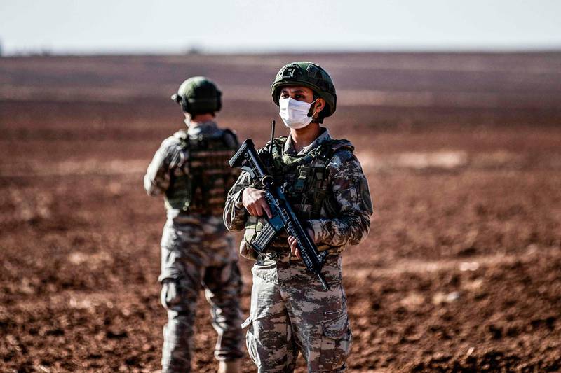 Turkish soldiers stand guard during a joint Russian-Turkish patrol in the eastern countryside of the town of Darbasiyah near the border with Turkey in Syria's northeastern Hasakah province.  AFP