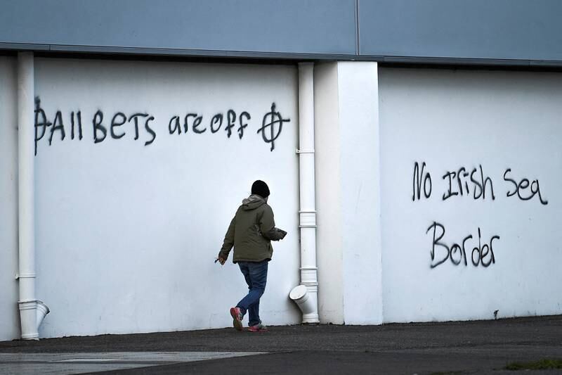 Loyalist graffiti with messages against the Brexit border checks in relation to the Northern Ireland protocol at the harbour in Larne, Northern Ireland February 12, 2021. Reuters