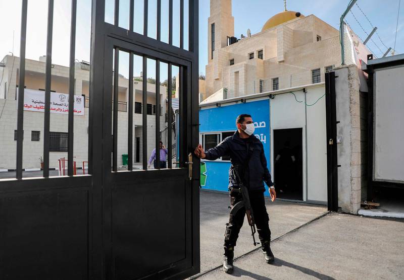 A Palestinian security guard stands at the entrance of a quarantine centre in the West Bank city of Nablus, on March 9, 2020. AFP