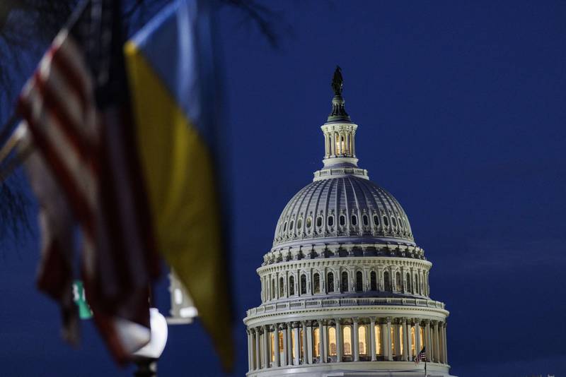 The US Capitol building can be seen past American and Ukrainian flags that were hung on the light posts lining Pennsylvania Avenue on Tuesday night. AFP