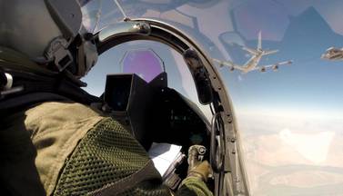 Mid-air refuelling allows fighter jets and larger aircraft to fly almost continuously. This photo provided by the French military in 2014 shows a pilot navigating his Rafale fighter jet for a mid-air refuelling en route to Iraq. EPA