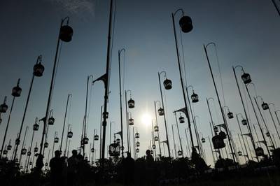 Birdcages are silhouetted against the sky. AFP