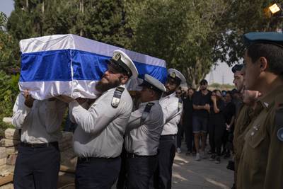 Israeli soldiers carry the coffin of Erik Kraunik, chief of security in the kibbutz of Be'eri, during his funeral at a cemetery in Yehud, Israel. AP